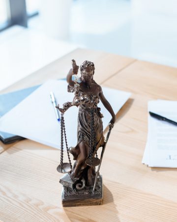 lawyer workplace with themis sculpture in modern office